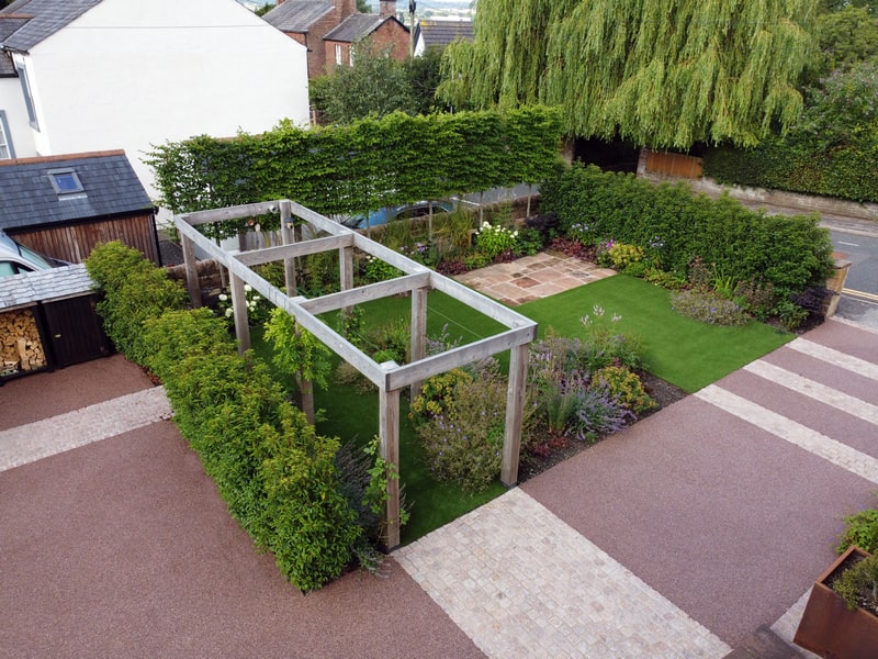 Pleached Hornbeam, Laurel hedging and a larch pergola offering privacy to a garden