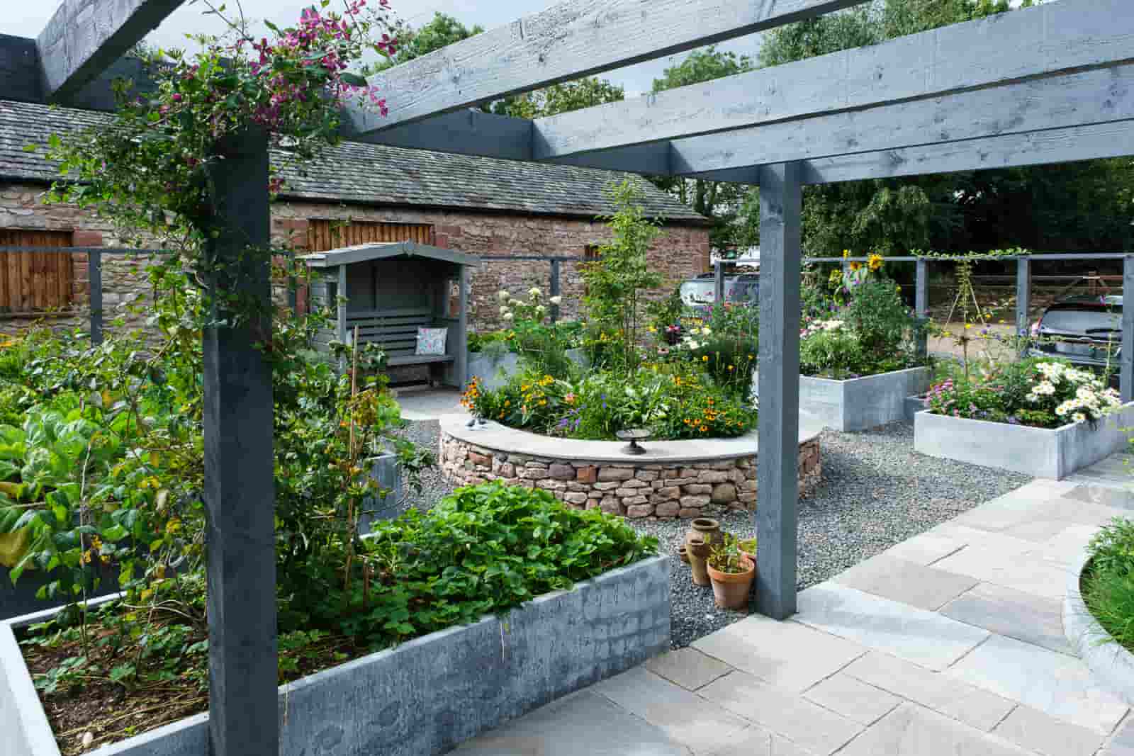 Landscaped patio with a pergola structure, raised beds and gravel, Morland Cumbria